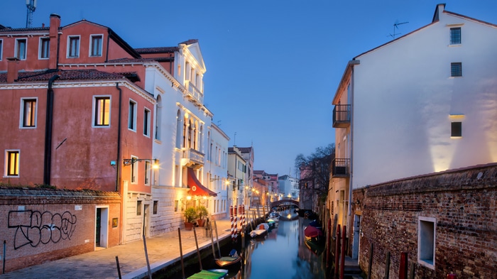 Venice Canal at Dusk with Boats and Buildings