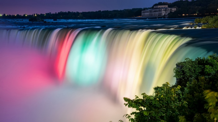 Niagara Falls illuminated with colorful lights at night