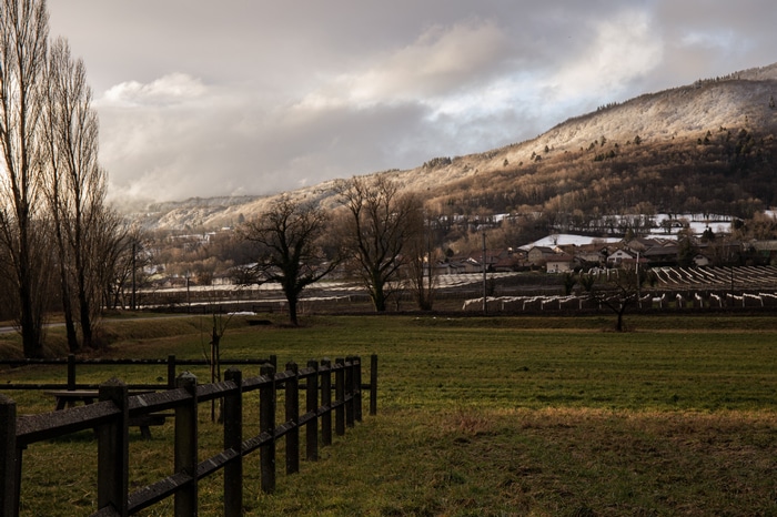 Winter landscape with snow-covered mountains and a village