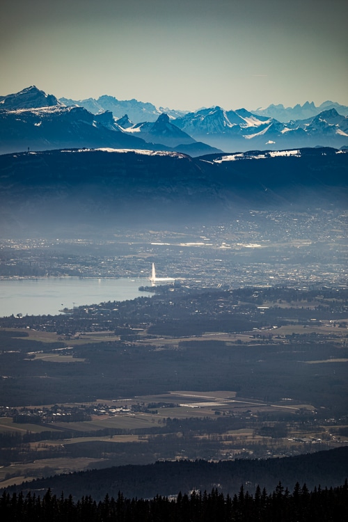 Geneva cityscape with fountain and French Alps in winter