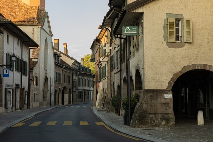 Street in a Swiss village with arches and buildings
