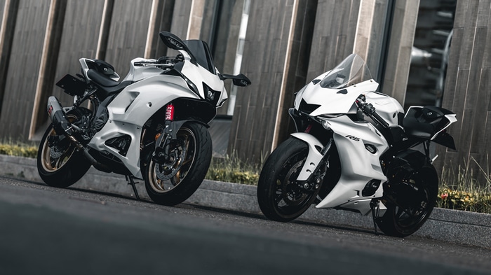 Two white Yamaha YZF motorcycles on a road
