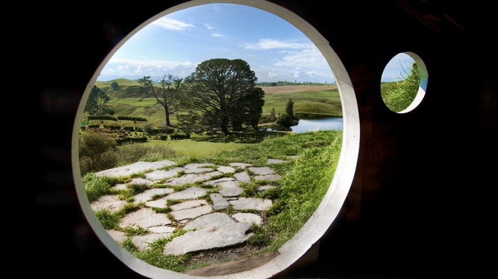 Hobbiton, New Zealand landscape viewed through a round opening