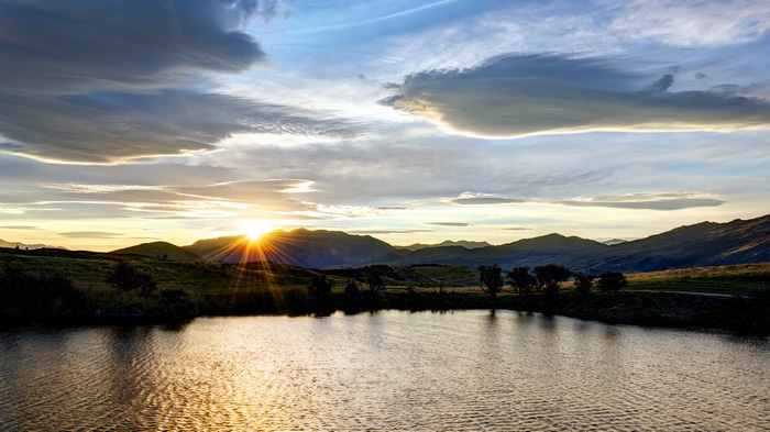 4K sunset over mountains and water