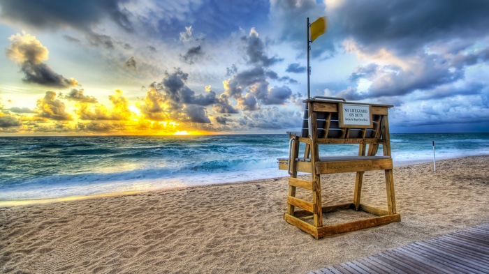 4K Sunset over the Ocean with Lifeguard Stand