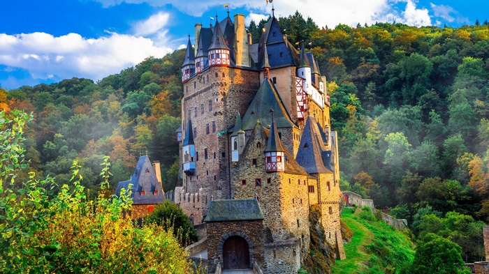 4K Eltz Castle surrounded by autumn forest