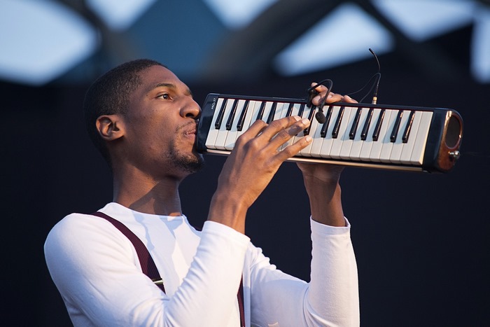 Jon Batiste plays a melodica