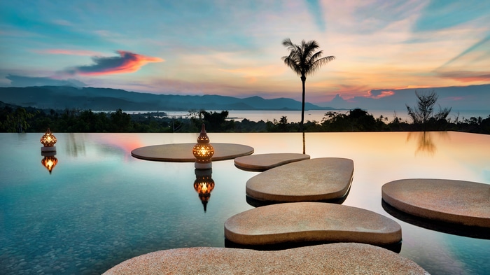 4K Sunset Over Infinity Pool with Palm Tree