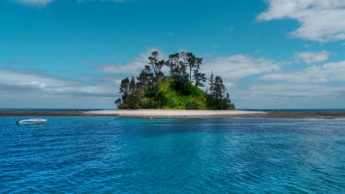 4K Island with Boat and Blue Water