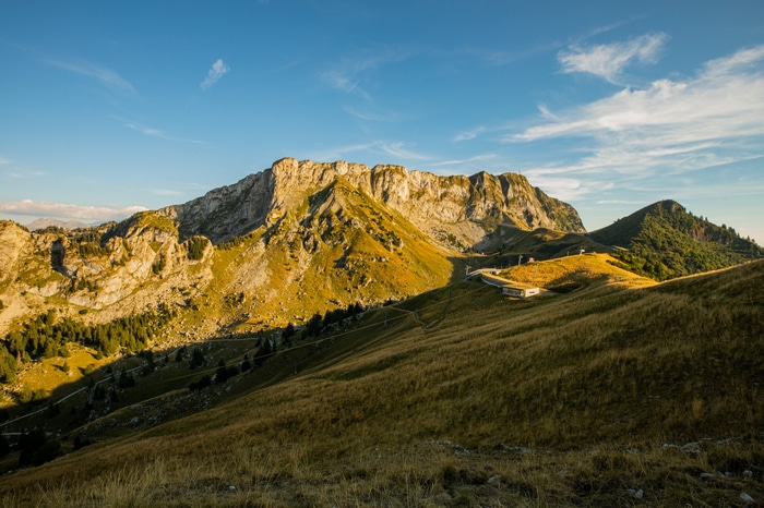Mountain landscape with grassy slopes and rocky peaks