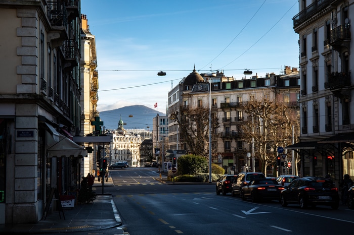 Street view in Geneva with buildings and mountains