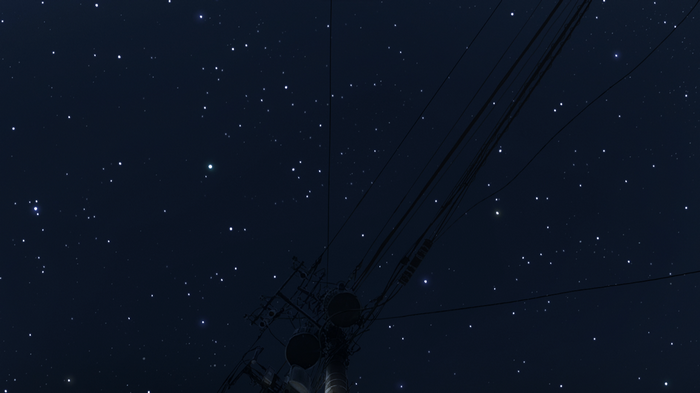 Starry night sky with power lines and utility pole