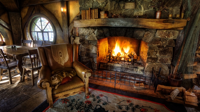 Hobbiton interior with fireplace and cat