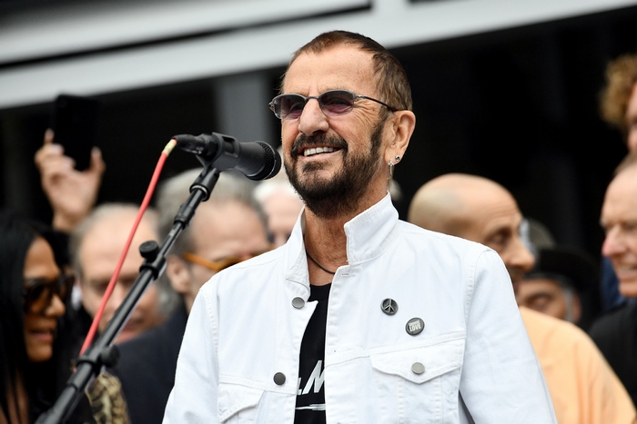 Ringo Starr speaks at a microphone