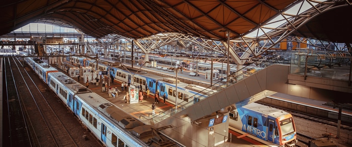 Melbourne train station with multiple trains and platforms