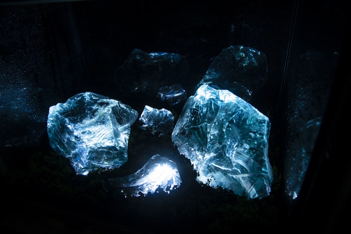 Glass shards with blue light in dark aquarium
