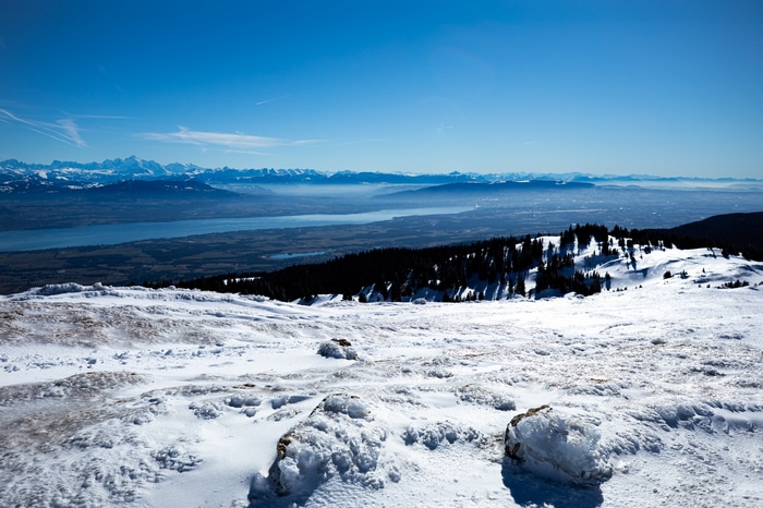 Snowy mountain landscape overlooking a lake and French Alps