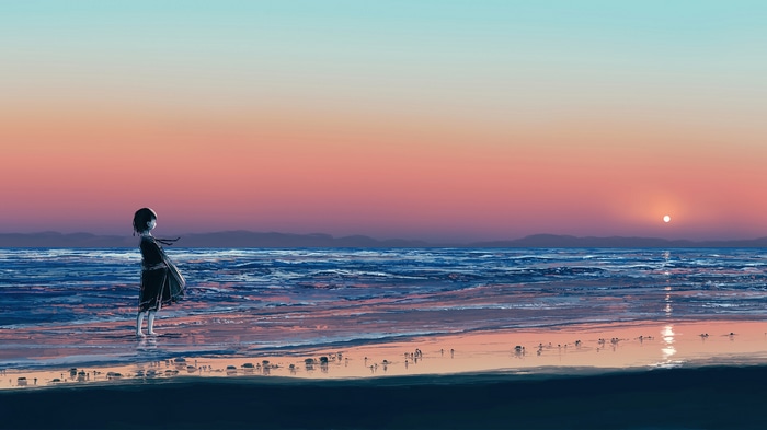 Girl standing on a beach at sunset