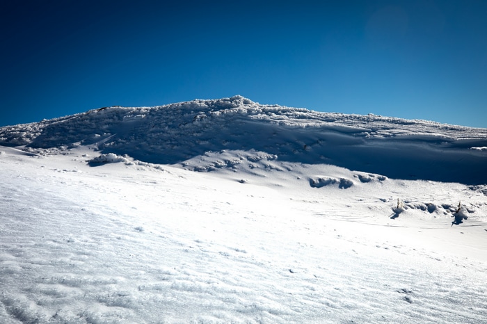 Snowy mountain ridge under a clear blue sky