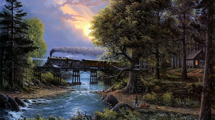 Steam locomotive crosses a bridge over a river at sunset