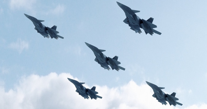 Five fighter jets flying in formation