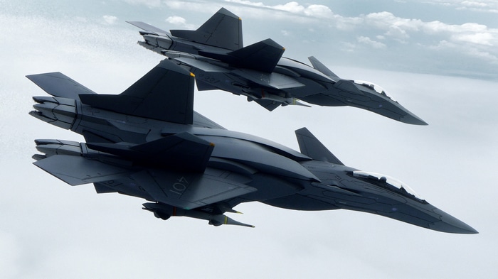 Two futuristic military aircraft flying in the sky