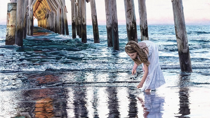Girl in white dress by a pier at the sea