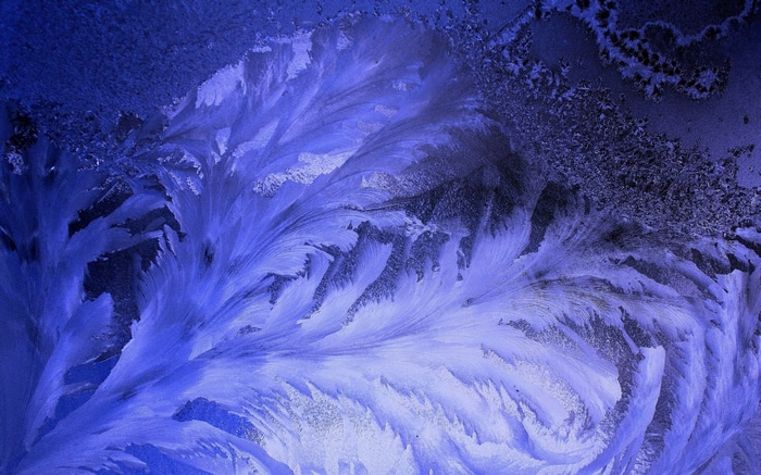 Close-up of frost patterns on glass in winter
