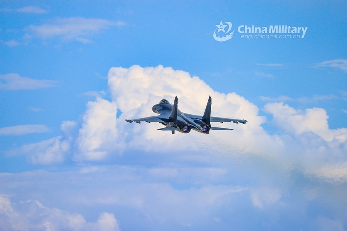 Chinese military jet fighter flying through clouds