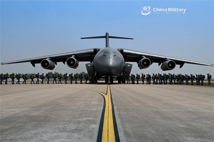 Military aircraft and soldiers on tarmac