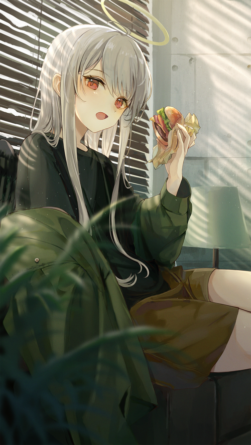 Girl with halo eating a burger near blinds