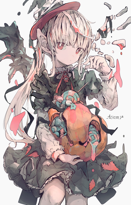 Girl in a witch hat holding a pumpkin with candy