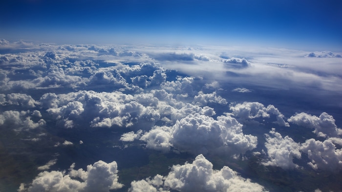 Clouds and sky from an airplane window