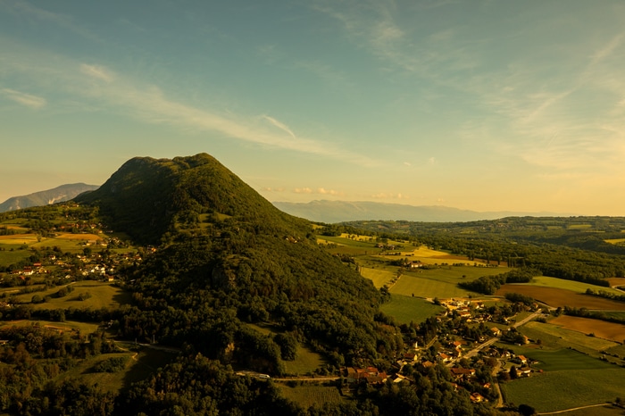 Green mountain landscape with a village and fields