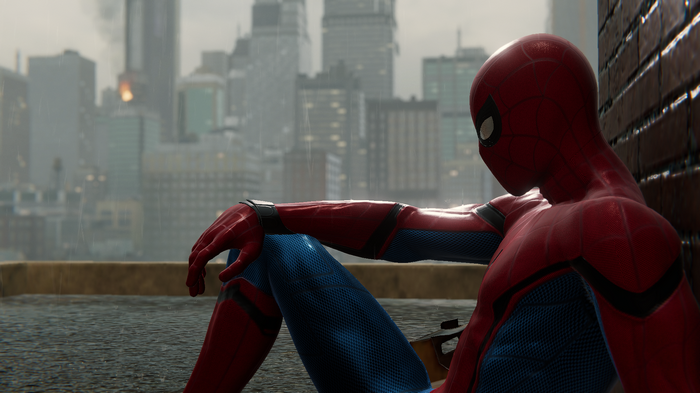 Spider-Man sitting on a rooftop in the rain