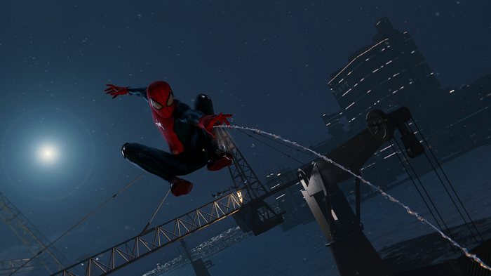 Spider-Man swinging through a city at night