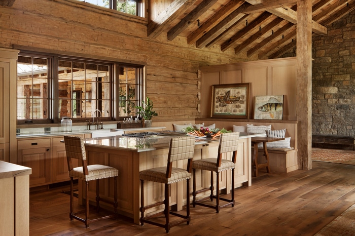 Rustic log cabin kitchen with island and bar stools