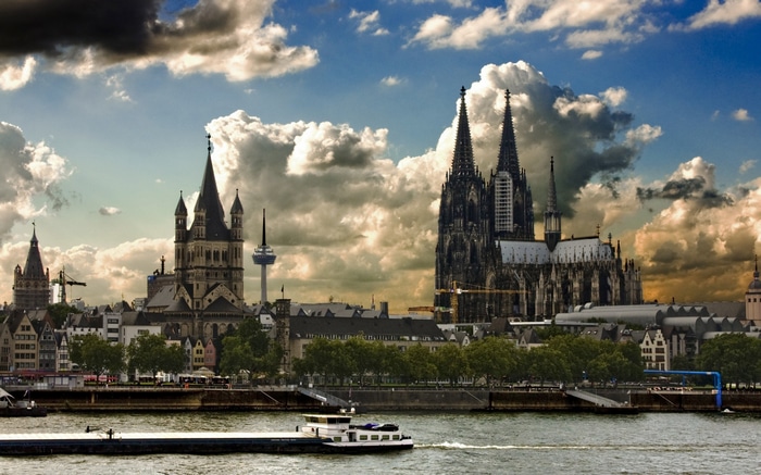 Cologne Cathedral and cityscape with river barge