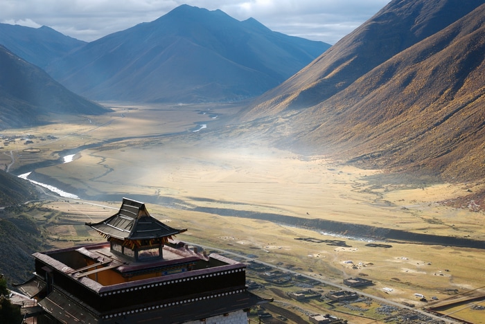 Monastery in a Tibetan Valley with Mountains