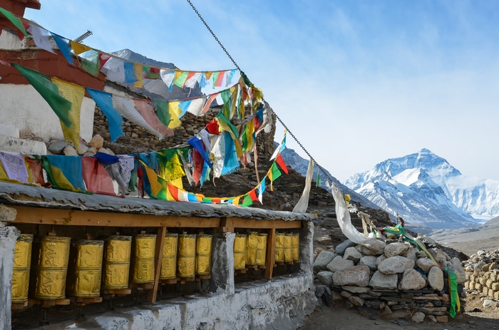 Prayer wheels and prayer flags with Mount Everest in the background