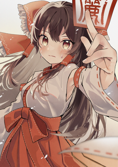 Hakurei Reimu from Touhou holding a talisman