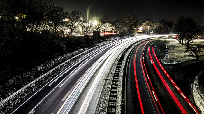 4K long exposure of a highway at night with light trails