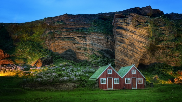 4K Iceland landscape with houses and rock wall