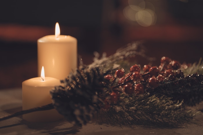 Christmas candles and berries with bokeh