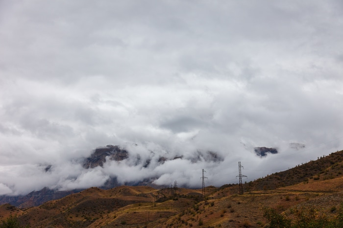 Clouds over mountains with pylons in Russia