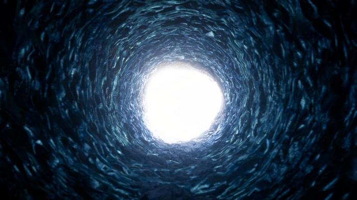 A dark tunnel with bright light at the end