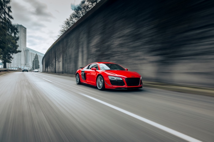 Red Audi R8 driving on a street