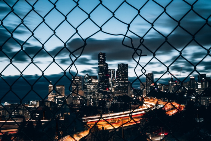 4K Seattle Cityscape at Night Through Chain Link Fence
