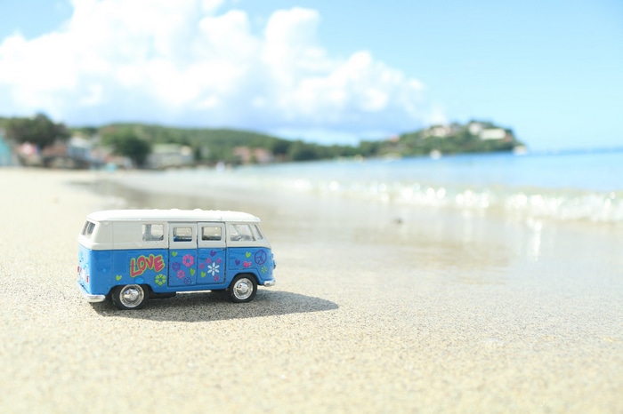 Blue Volkswagen toy van on a beach