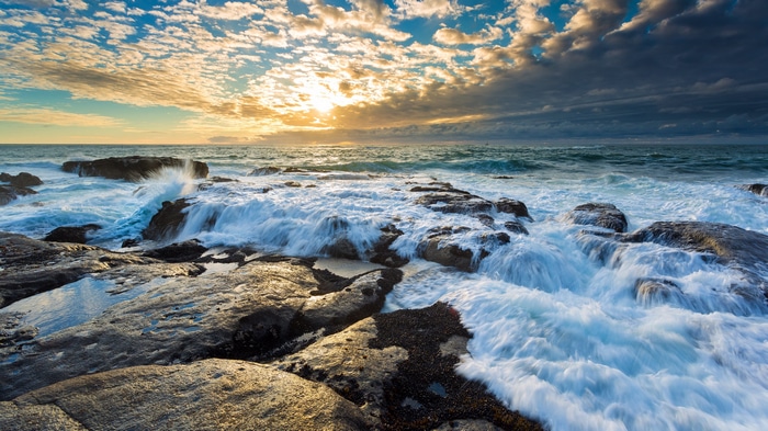 4K Sunset over Rocky Coastline with Waves